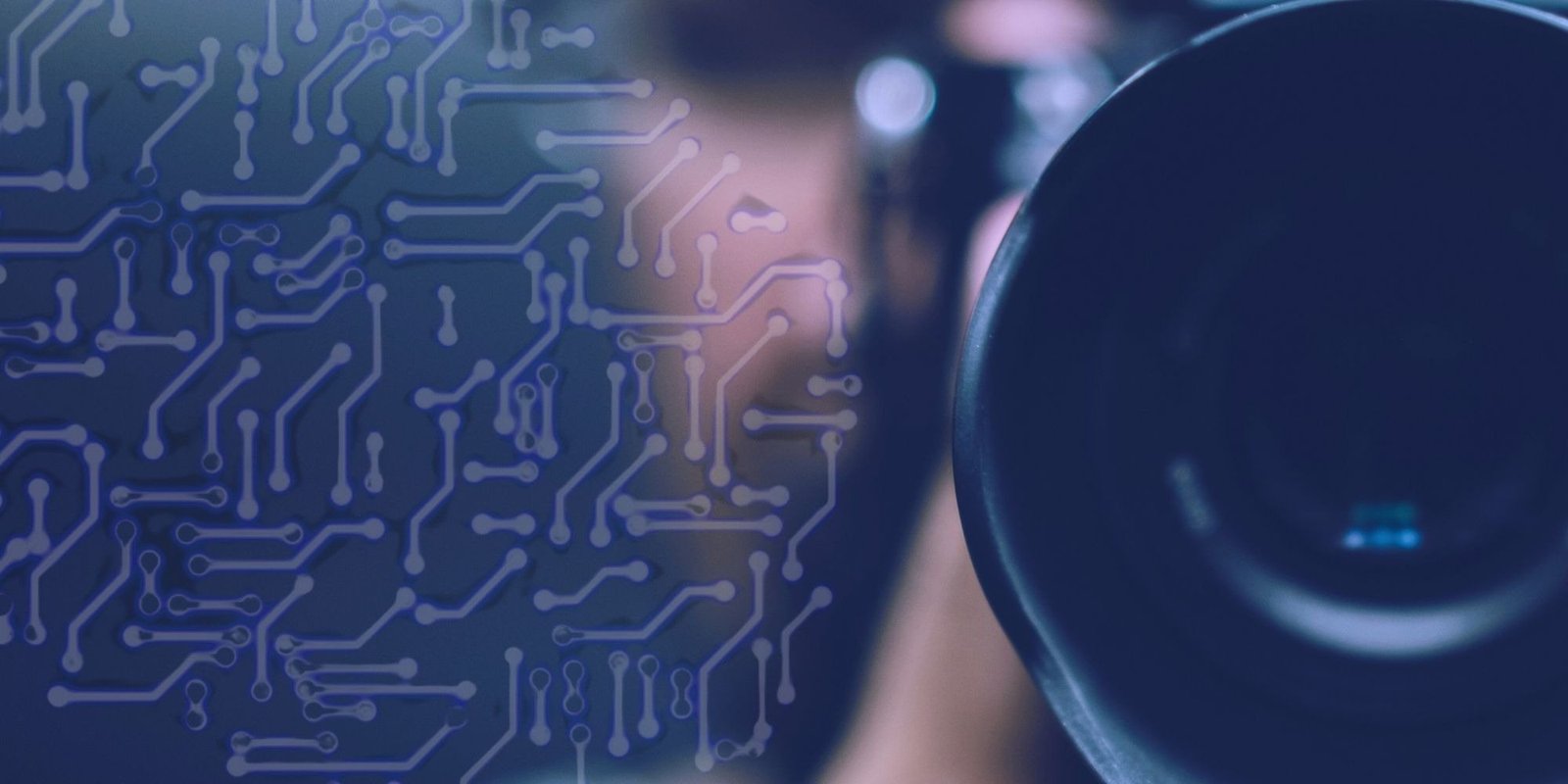 A camera lens against a blue circuit board pattern, the camera as a computer