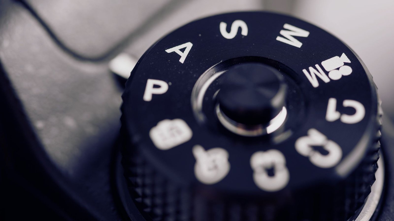 Close up of a camera mode dial showing the P, A, S and M settings