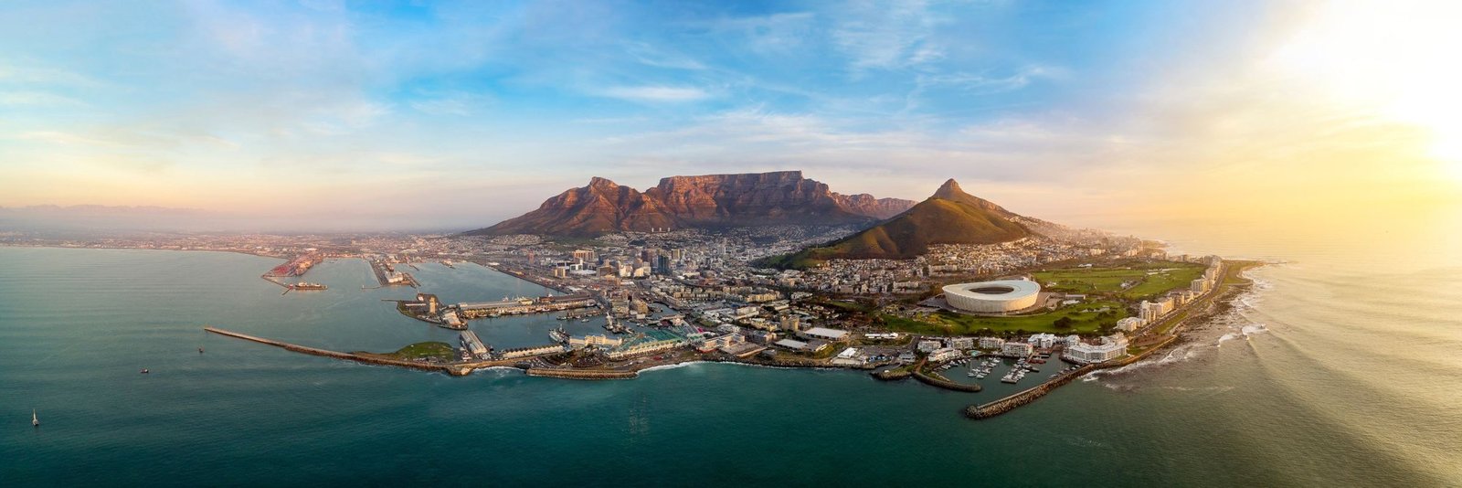 Cape Town from the air at sunrise, with Table Mountain, the harbour and the coast